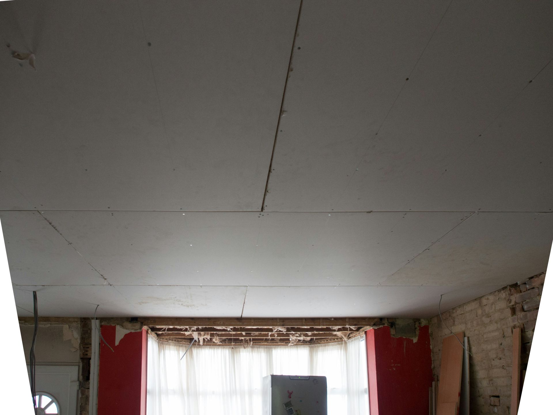 a room with a window and a white ceiling
